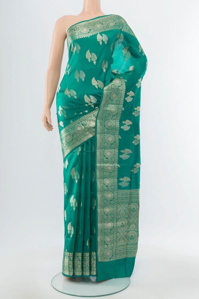 Light Blue Banarasi Raw Silk Saree with Zari Butta on the body and Silk Border.  displayed on a mannequin