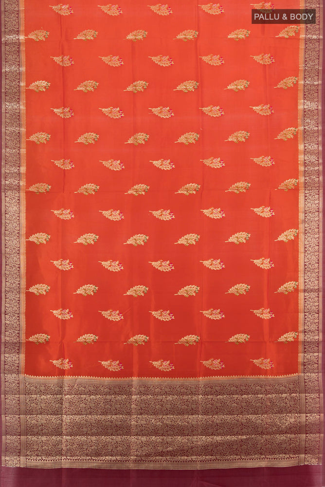 Flat view of Pure Silk Pure Zari Rust Banarasi Raw Saree with Zari Butta on the body and Silk Border. 