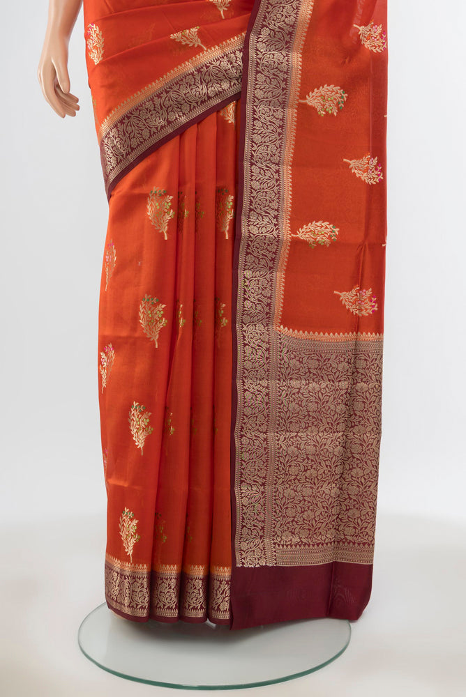 Pleats and pallu of Pure Silk Pure Zari Rust Banarasi Raw Saree with Zari Butta on the body and Silk Border. 