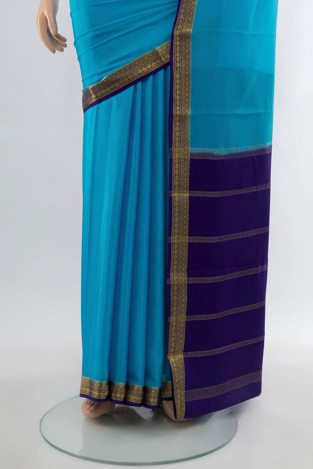 Pleats and pallu of Light Blue Mysore Crepe Saree with Plain Body and Zari Border. 