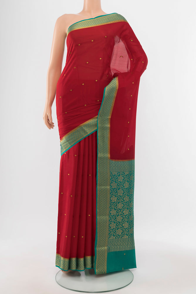 Red Mysore Crepe Saree with Zari Butta on the body and Silk Border.  displayed on a mannequin