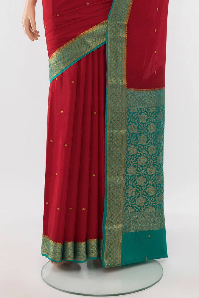 Pleats and pallu of Red Mysore Crepe Saree with Zari Butta on the body and Silk Border. 