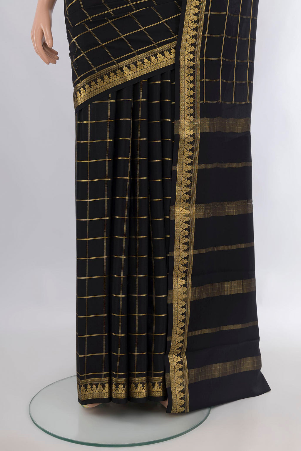 Pleats and pallu of Black Mysore Crepe Saree with Checked design on the body and Zari Border. 