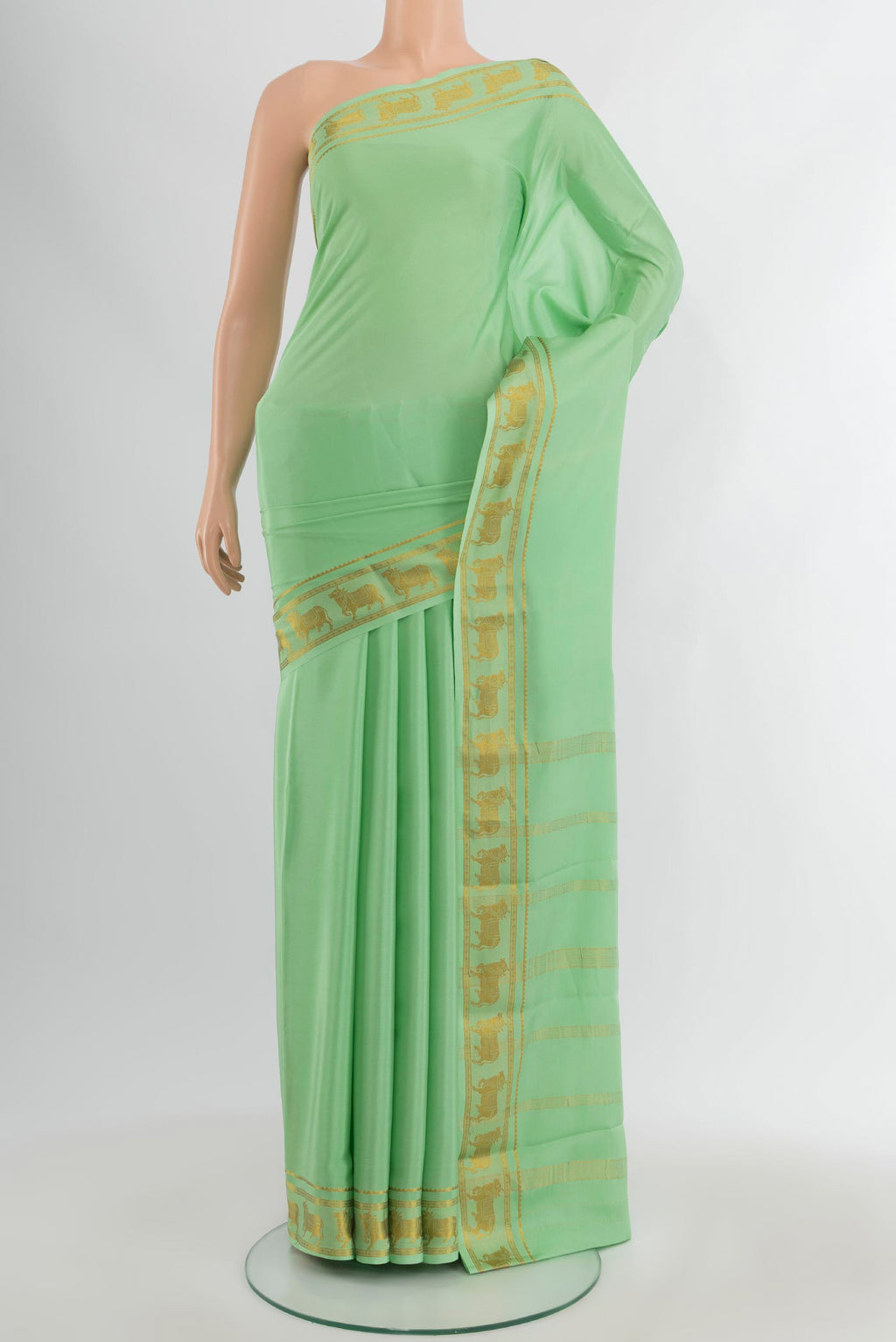 Pista Green Mysore Crepe Saree with Plain Body and Zari Border.  displayed on a mannequin