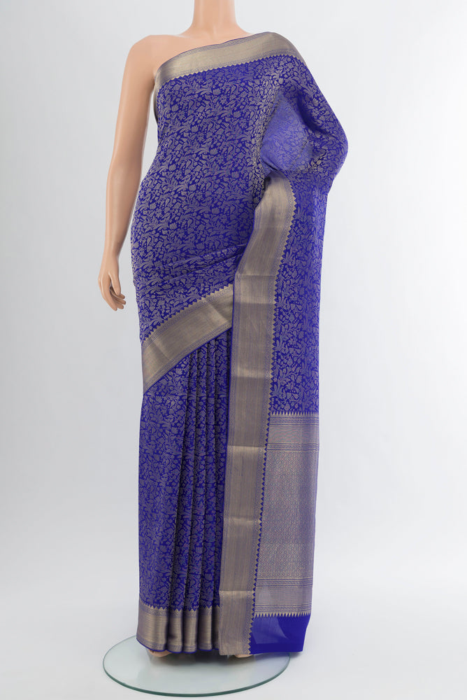 Pure Silk Pure Zari Light Blue Georgette Saree with Zari Butta on the body and Silk Border.  displayed on a mannequin