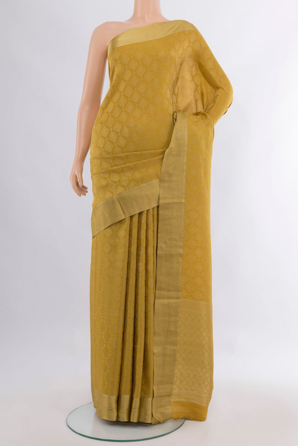 Mustard Mysore Crepe Saree with Zari Brocade on the body and Zari Border.  displayed on a mannequin