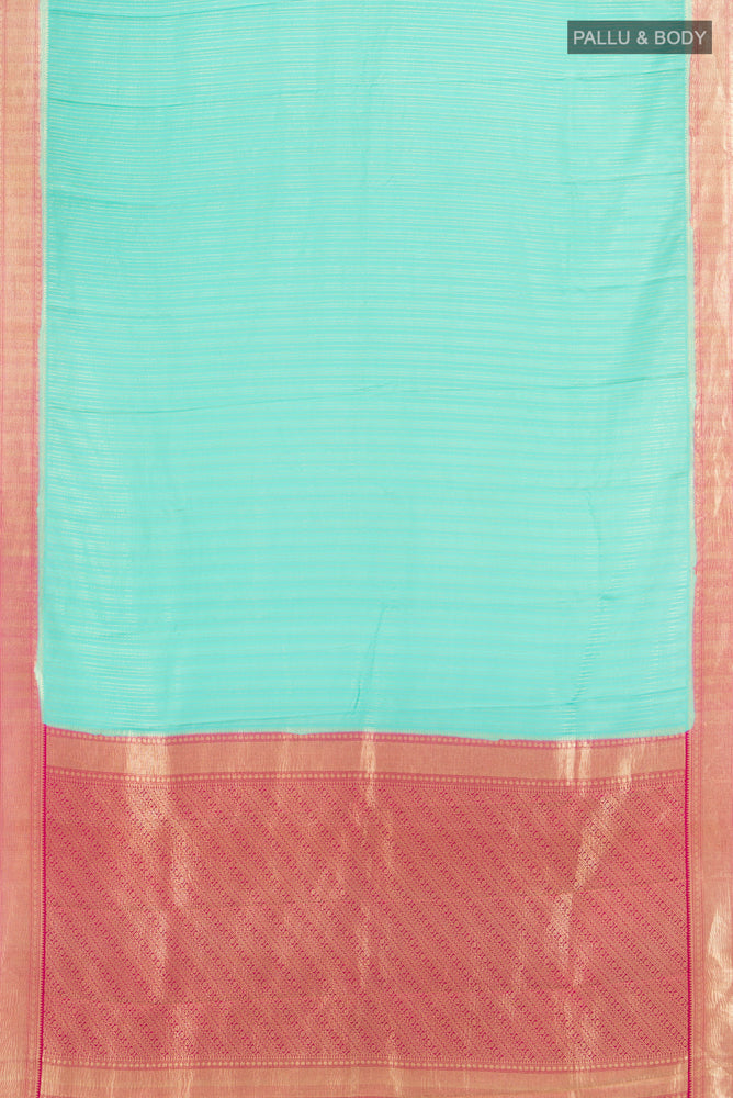 Flat view of Sky Blue Mysore Crepe Saree with Zari Butta on the body and Silk Border. 