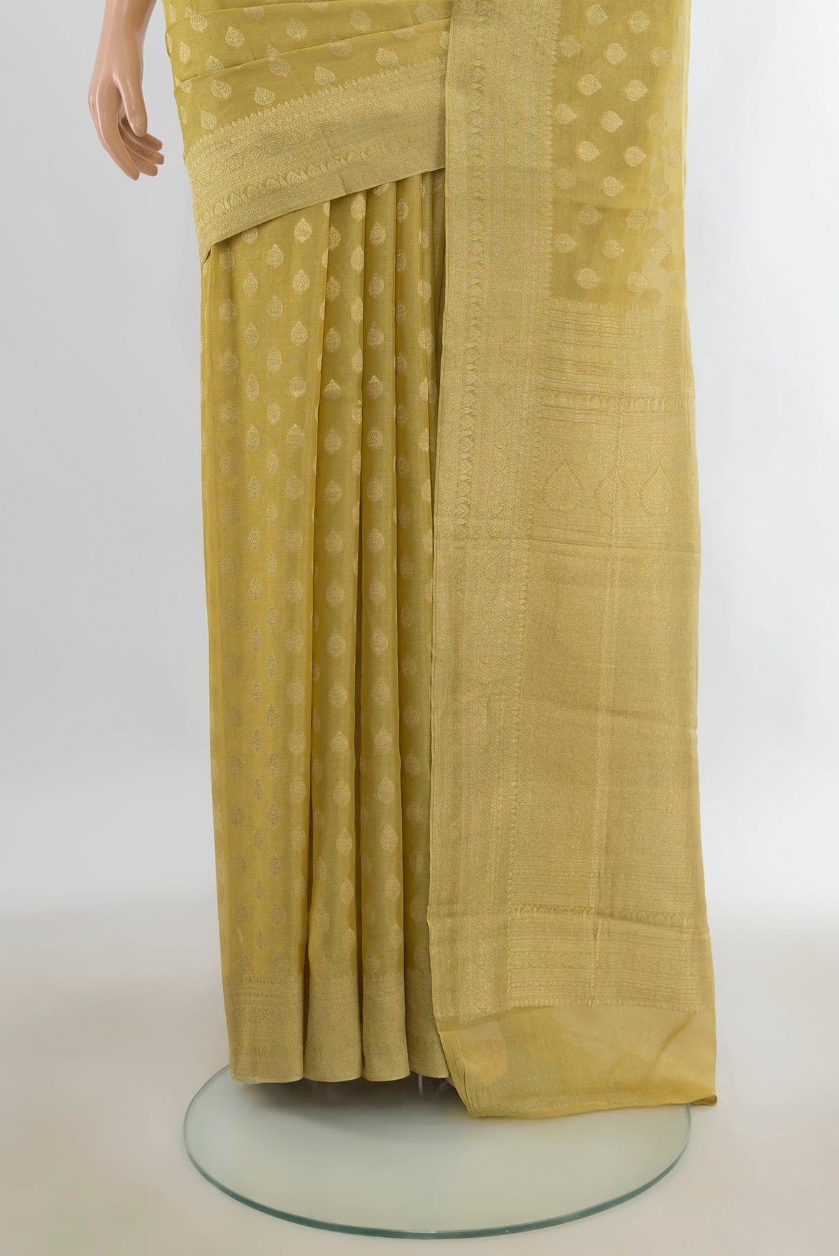 Pleats and pallu of Yellow Mysore Georgette Saree with Zari Butta on the body and Zari Border. 