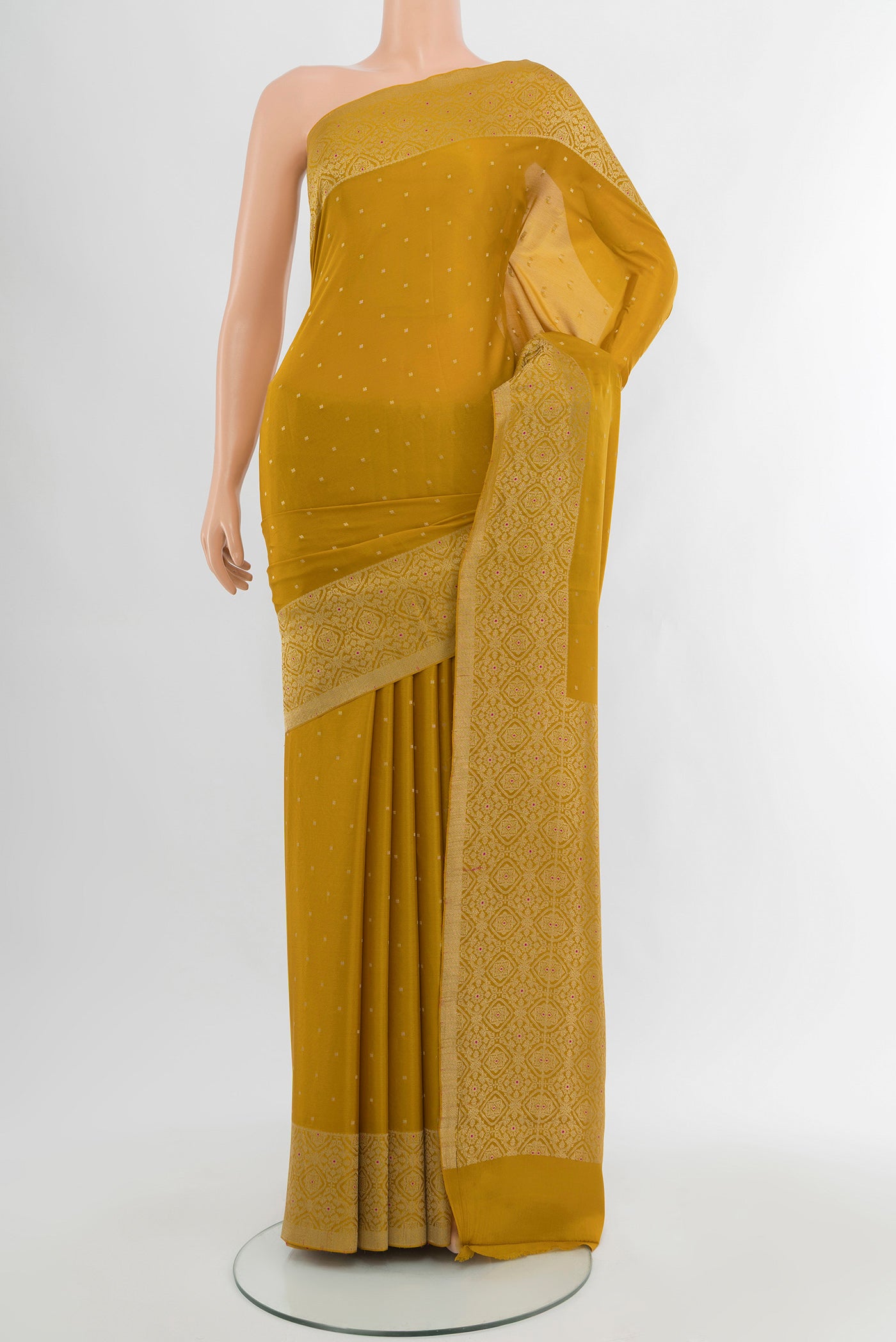 Mustard Mysore Crepe Saree with Zari Butta on the body and Zari Border.  displayed on a mannequin