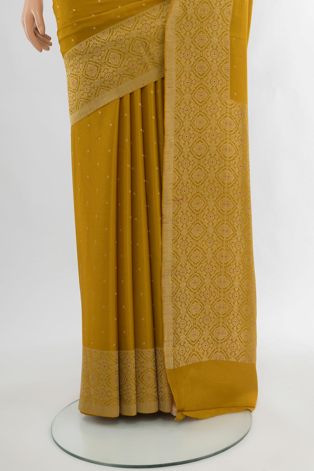 Pleats and pallu of Mustard Mysore Crepe Saree with Zari Butta on the body and Zari Border. 