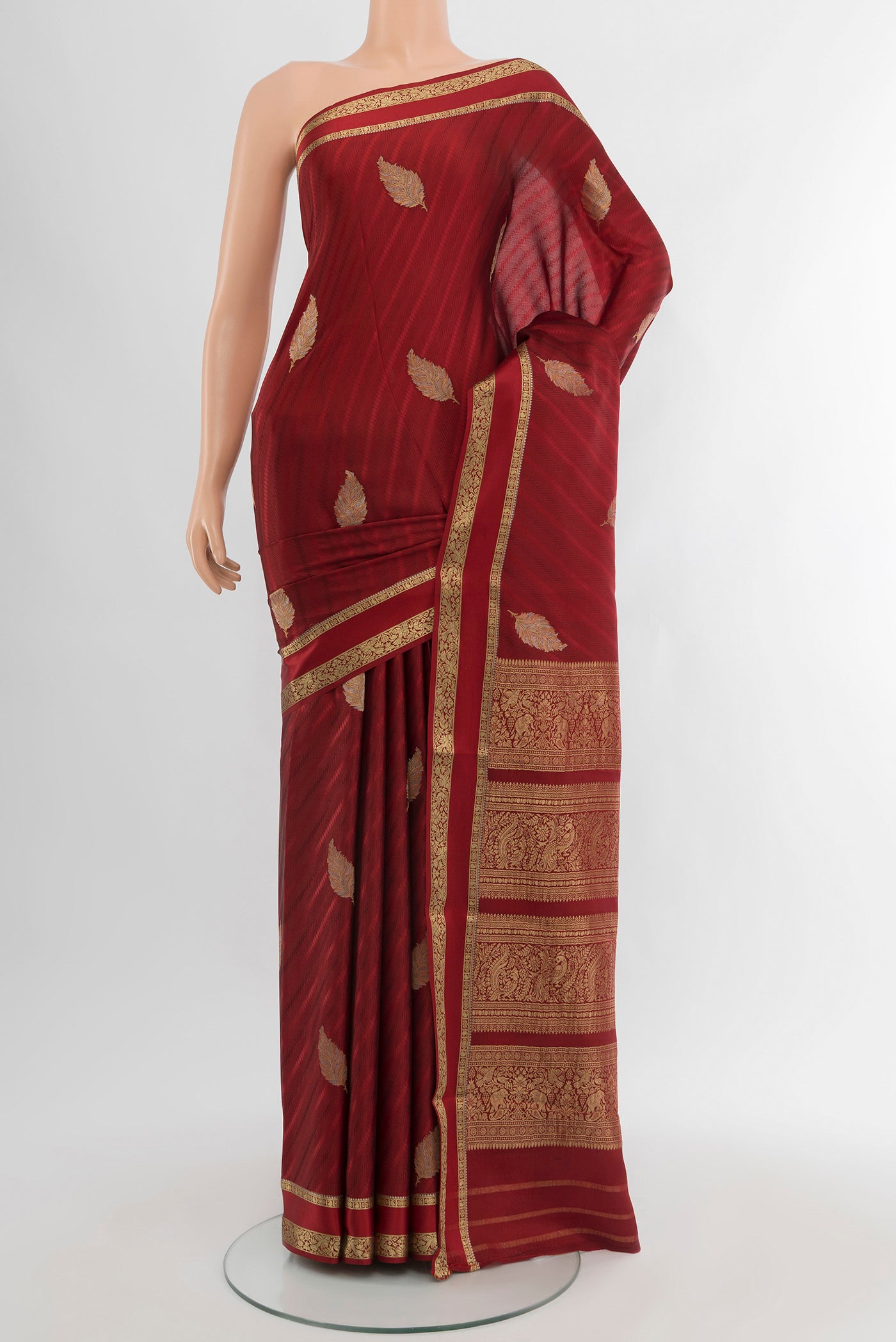 Maroon Mysore Crepe Saree with Zari Butta on the body and Zari Border.  displayed on a mannequin