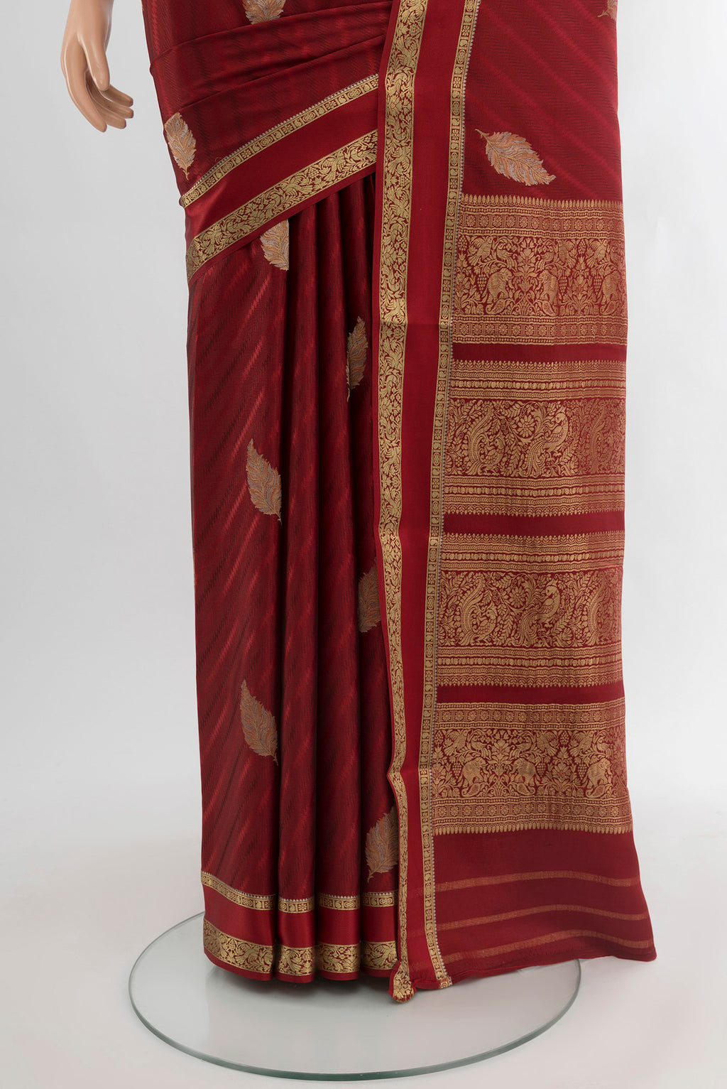 Pleats and pallu of Maroon Mysore Crepe Saree with Zari Butta on the body and Zari Border. 