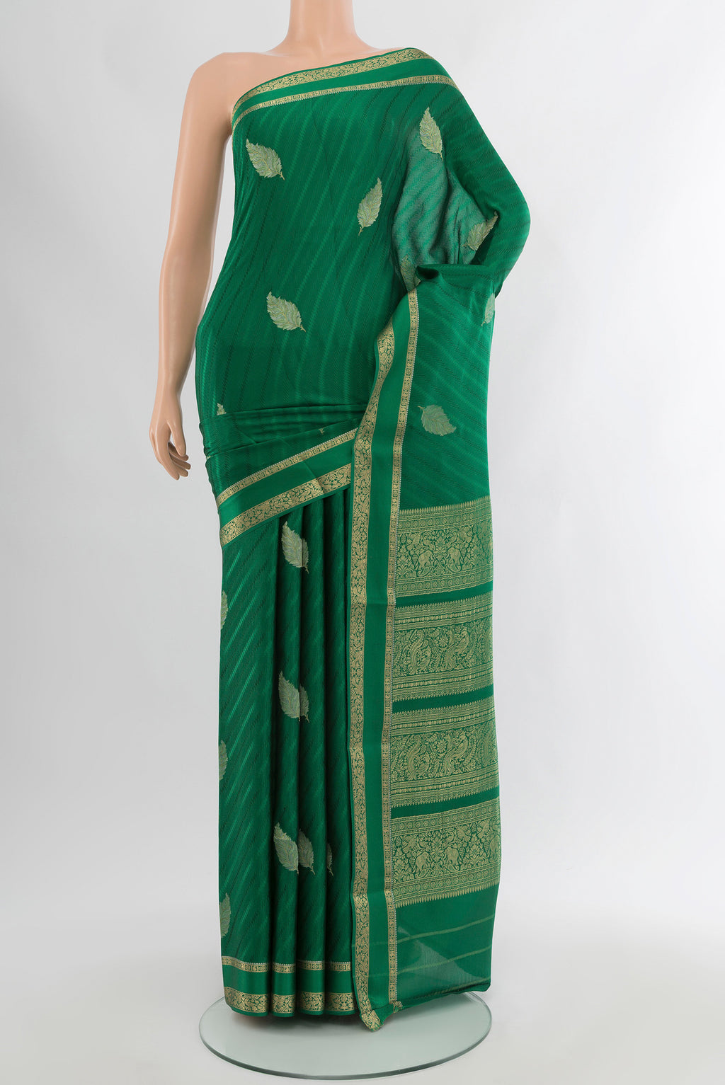 Green Mysore Crepe Saree with Zari Butta on the body and Zari Border.  displayed on a mannequin