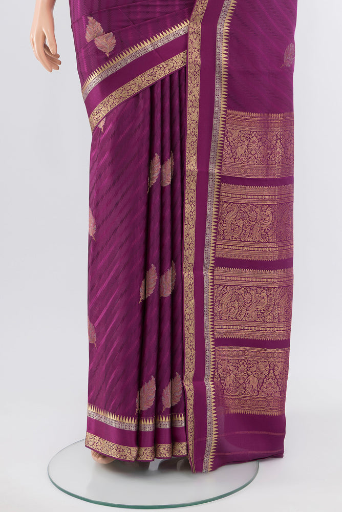 Pleats and pallu of Purple Georgette Saree with Zari Butta on the body and Silk Border. 