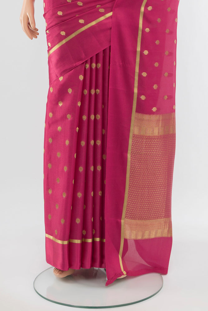 Pleats and pallu of Bronze Mysore Crepe Saree with Zari Butta on the body and Silk Border. 