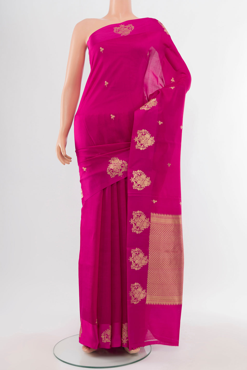 Magenta Banarasi Katan Silk Saree with Zari Butta on the body and Silk Border.  displayed on a mannequin