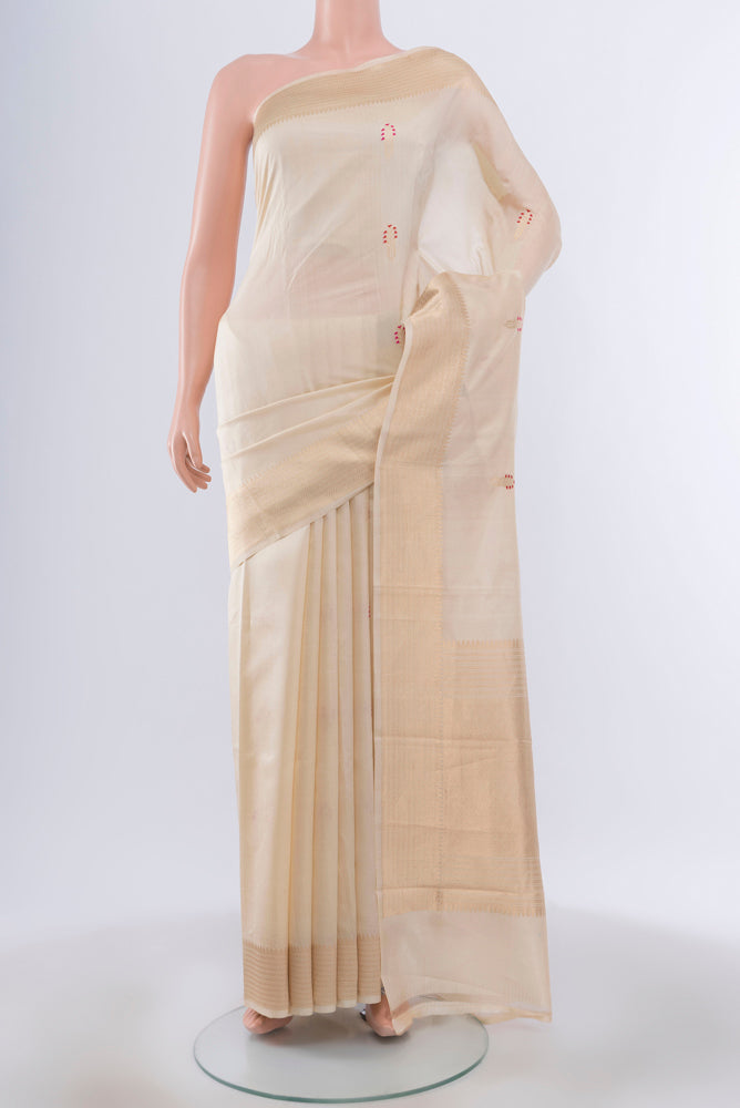 Cream Banarasi Katan Silk Saree with Zari Butta on the body and Silk Border.  displayed on a mannequin