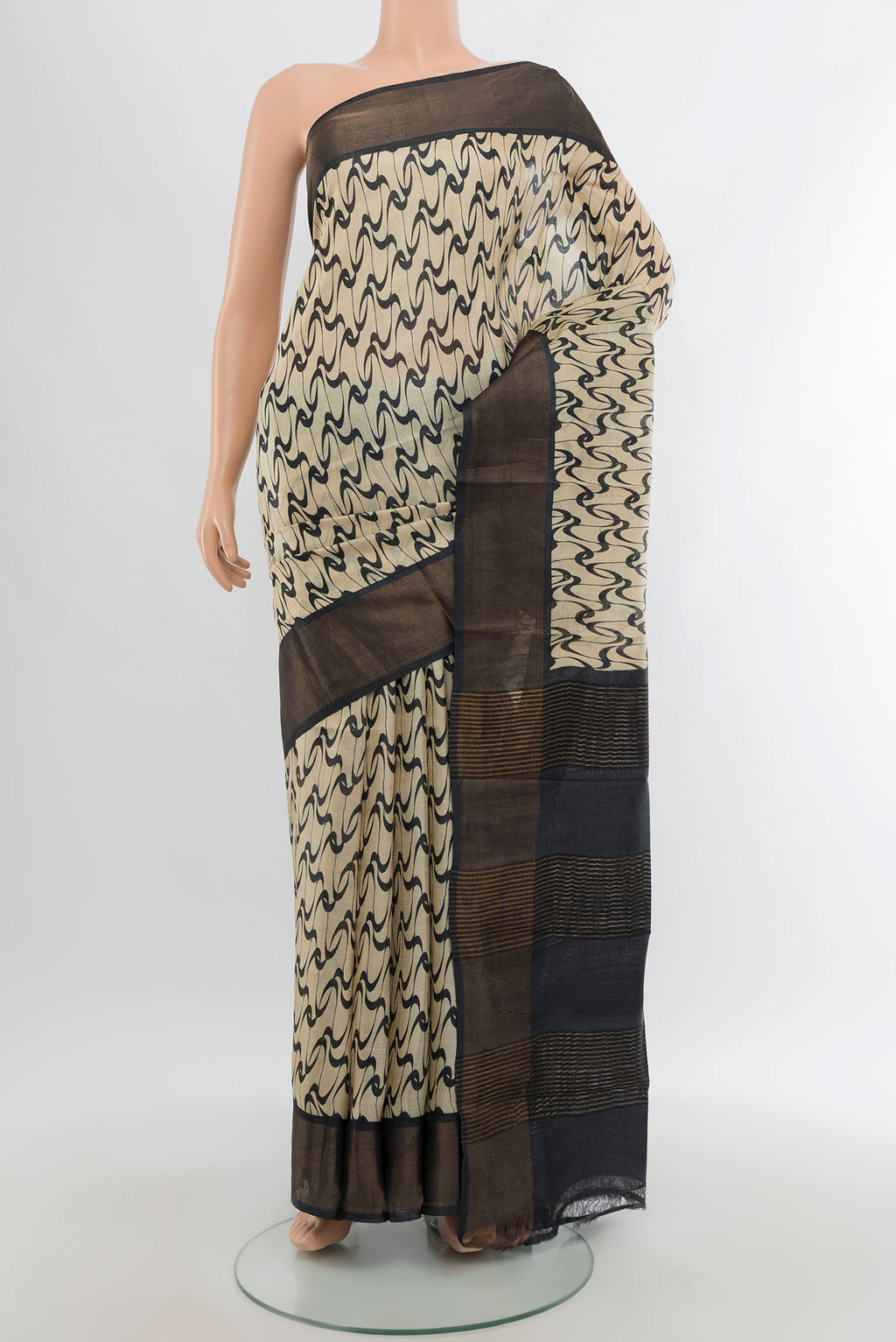 Cream Tussar Silk Saree with Printed design on the body and Zari Border.  displayed on a mannequin