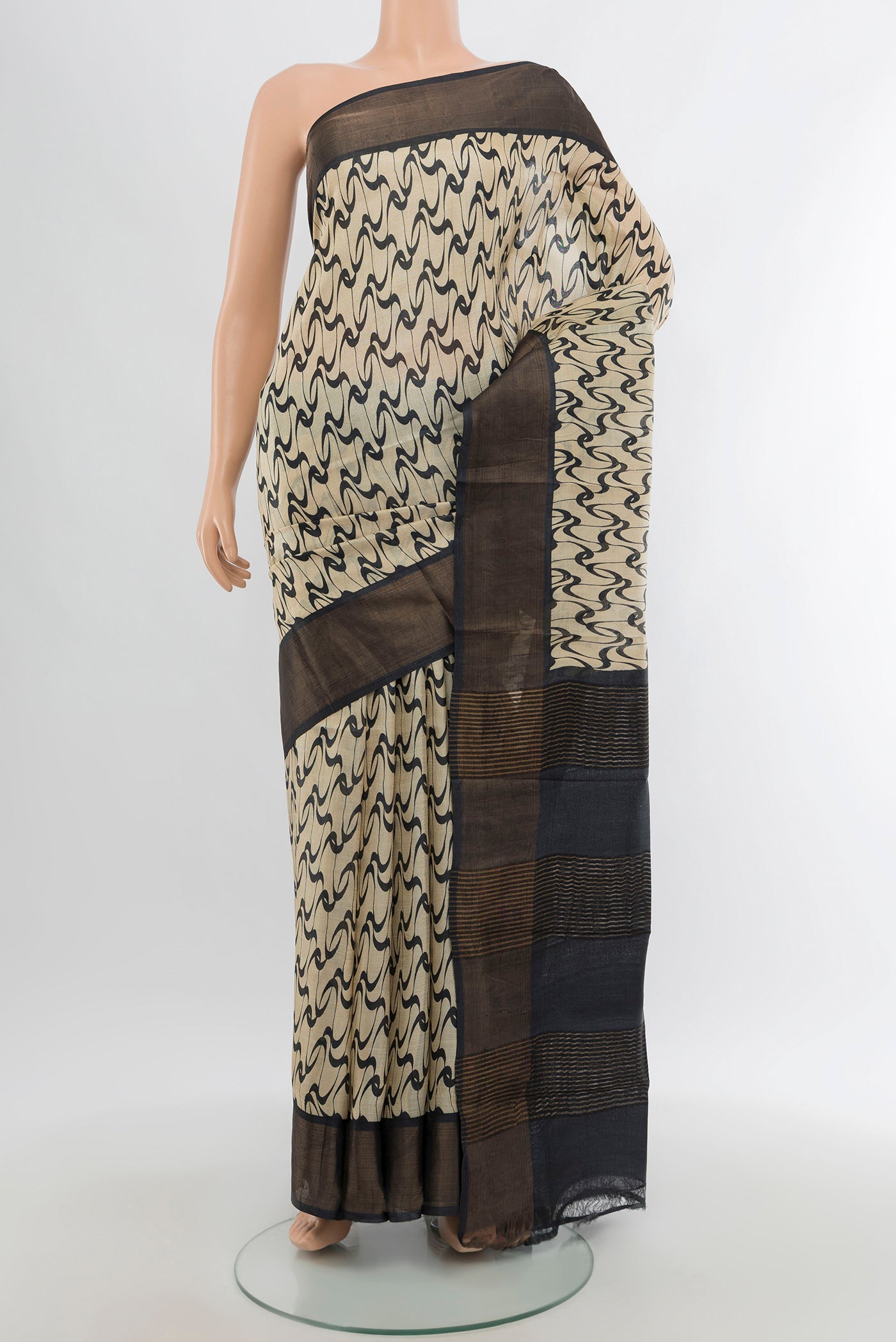 Cream Tussar Silk Saree with Printed design on the body and Zari Border.  displayed on a mannequin