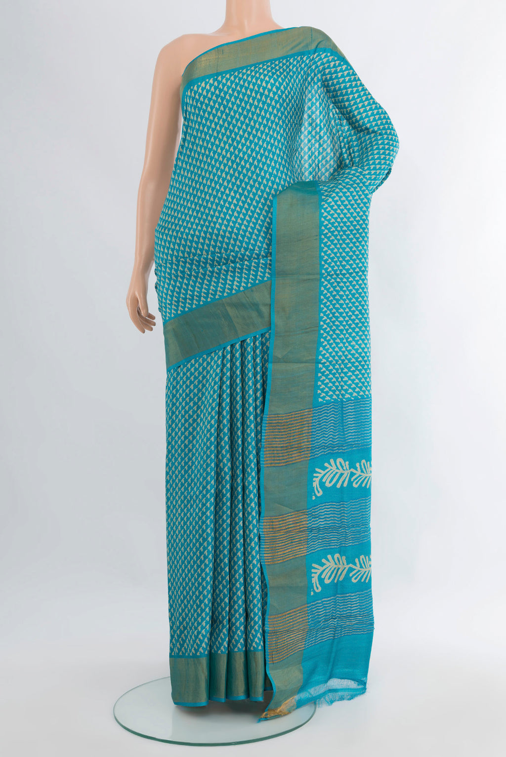 Light Blue Tussar Silk Saree with Floral Print on the body and Zari Border.  displayed on a mannequin