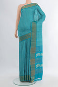 Light Blue Tussar Silk Saree with Floral Print on the body and Zari Border.  displayed on a mannequin