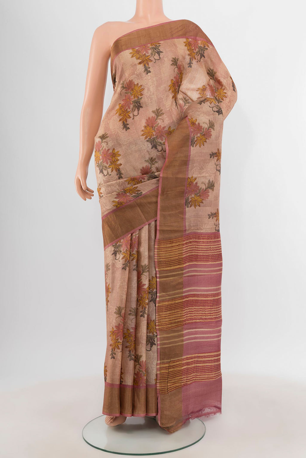 Rose Gold Tussar Silk Saree with Floral Print on the body and Zari Border.  displayed on a mannequin