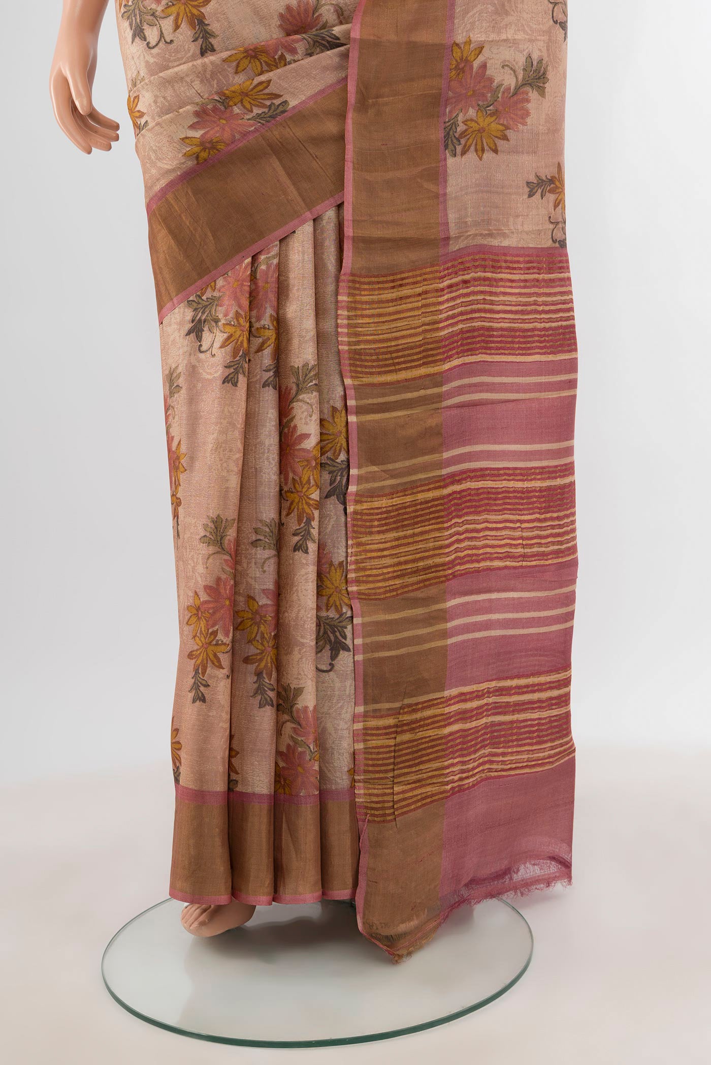 Pleats and pallu of Rose Gold Tussar Silk Saree with Floral Print on the body and Zari Border. 