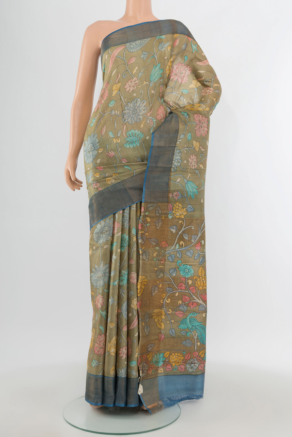 Beige Tussar Silk Saree with Floral Print on the body and Zari Border.  displayed on a mannequin