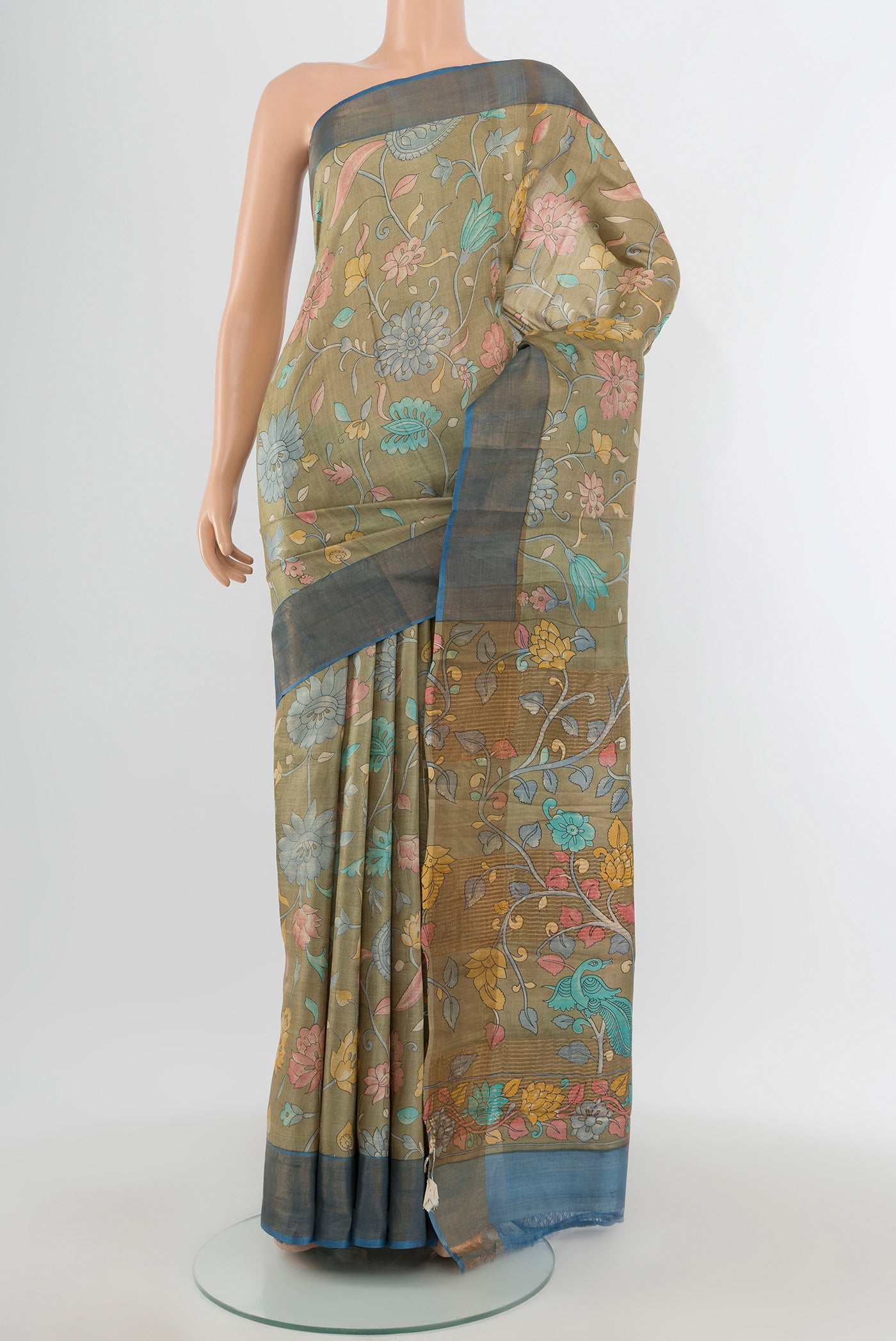 Beige Tussar Silk Saree with Floral Print on the body and Zari Border.  displayed on a mannequin