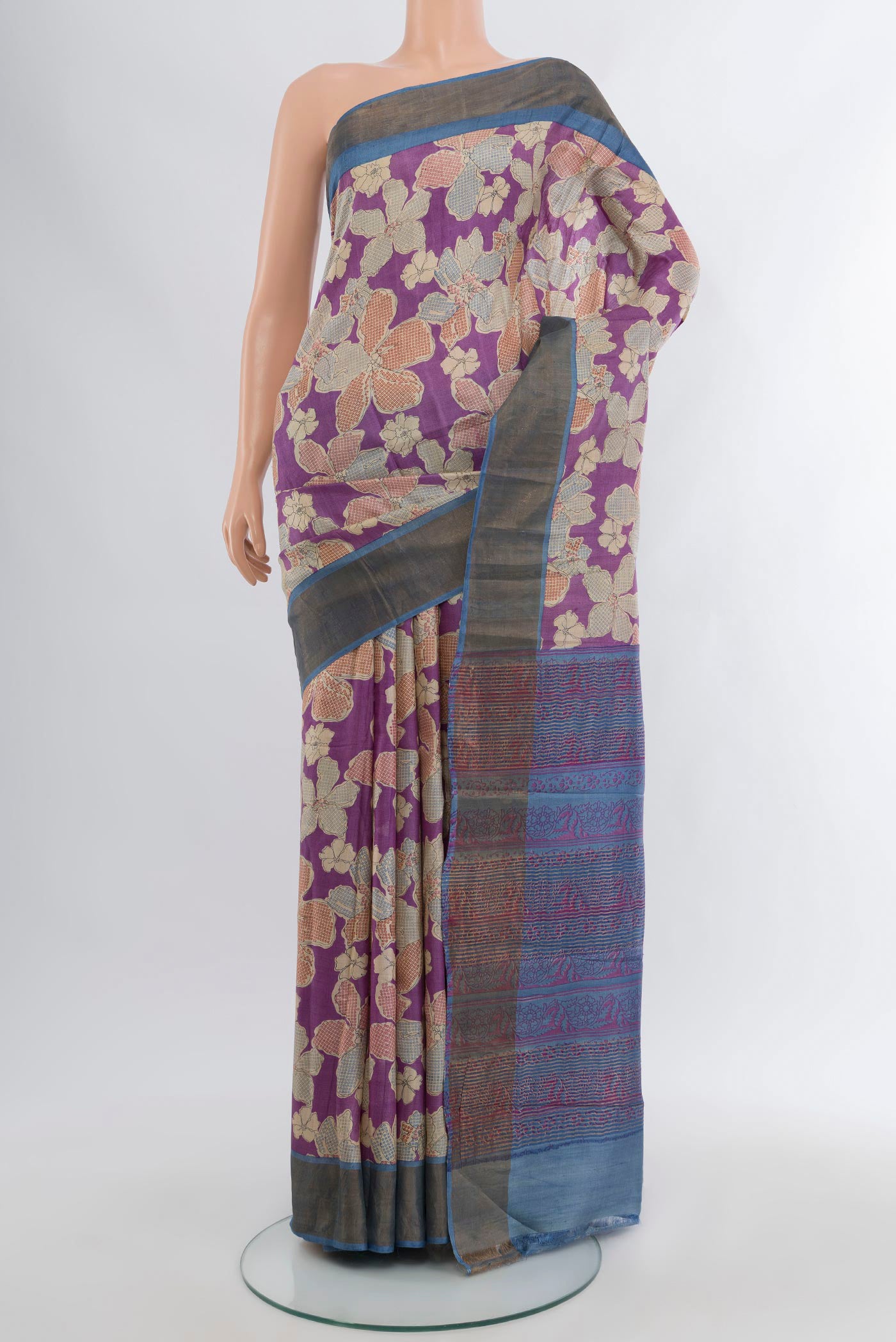 Purple Tussar Silk Saree with Floral Print on the body and Zari Border.  displayed on a mannequin
