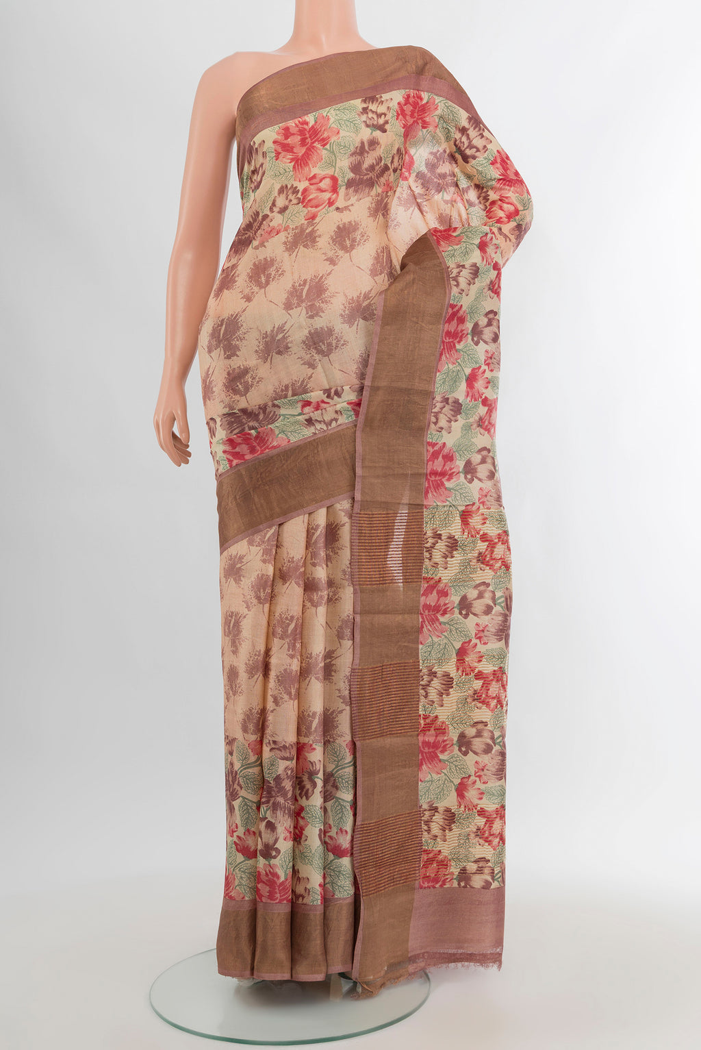 Beige Tussar Silk Saree with Floral Print on the body and Zari Border.  displayed on a mannequin