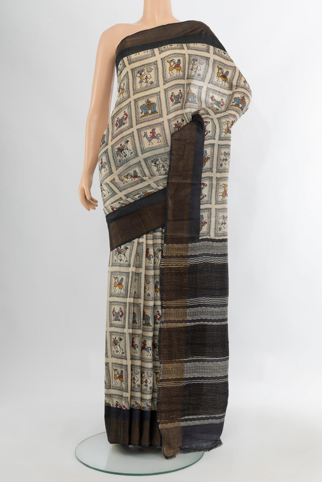 Off White Tussar Silk Saree with Printed design on the body and Zari Border.  displayed on a mannequin