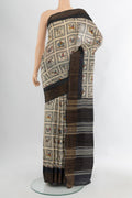 Off White Tussar Silk Saree with Printed design on the body and Zari Border.  displayed on a mannequin