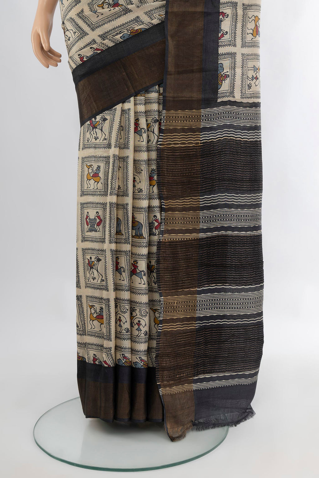 Pleats and pallu of Off White Tussar Silk Saree with Printed design on the body and Zari Border. 