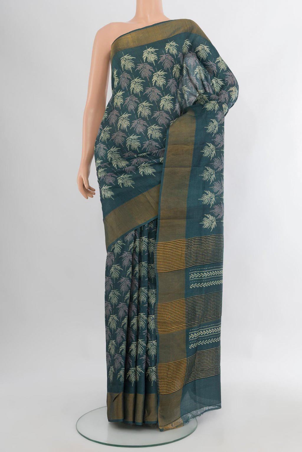 Green Tussar Silk Saree with Floral Print on the body and Zari Border.  displayed on a mannequin