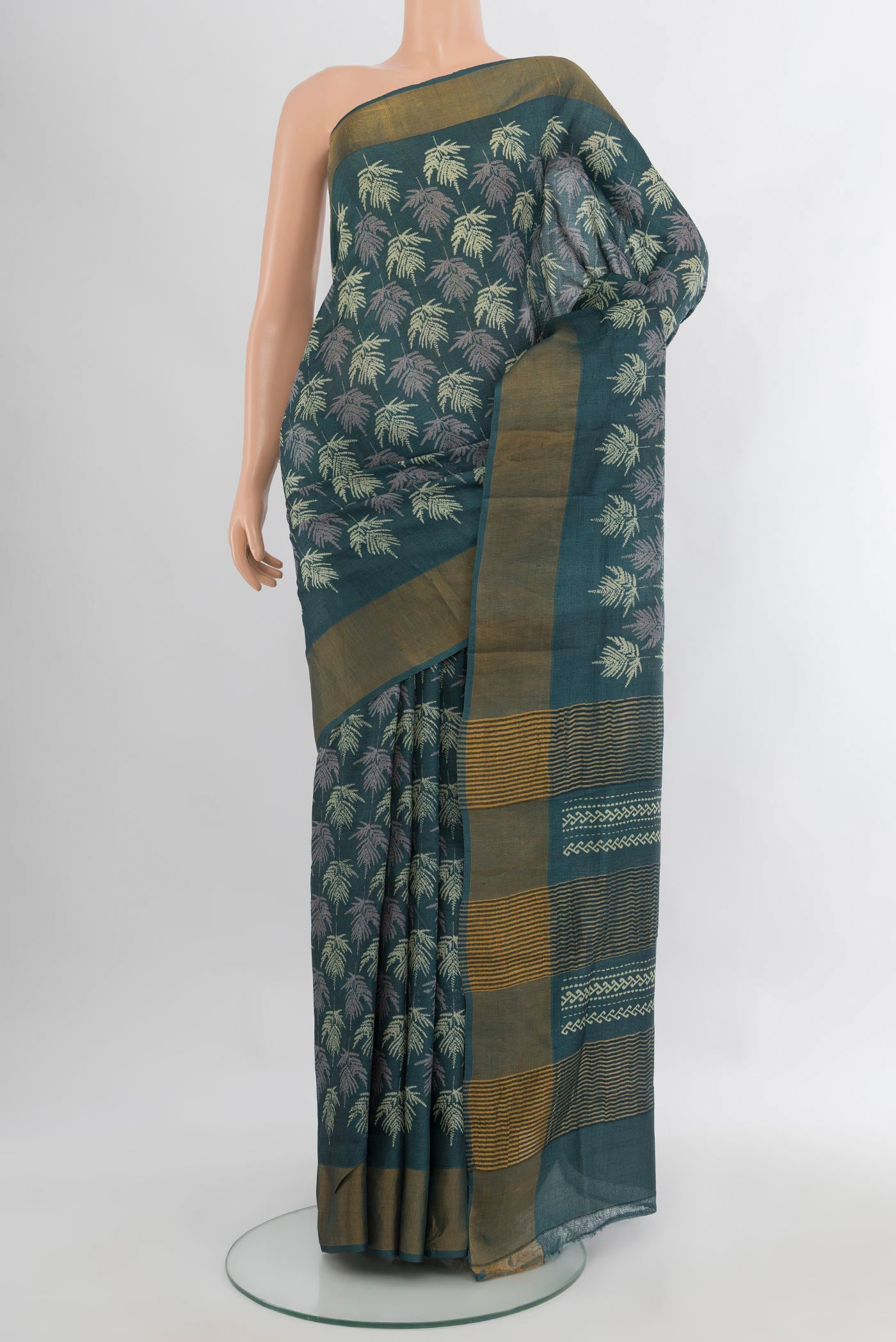 Green Tussar Silk Saree with Floral Print on the body and Zari Border.  displayed on a mannequin