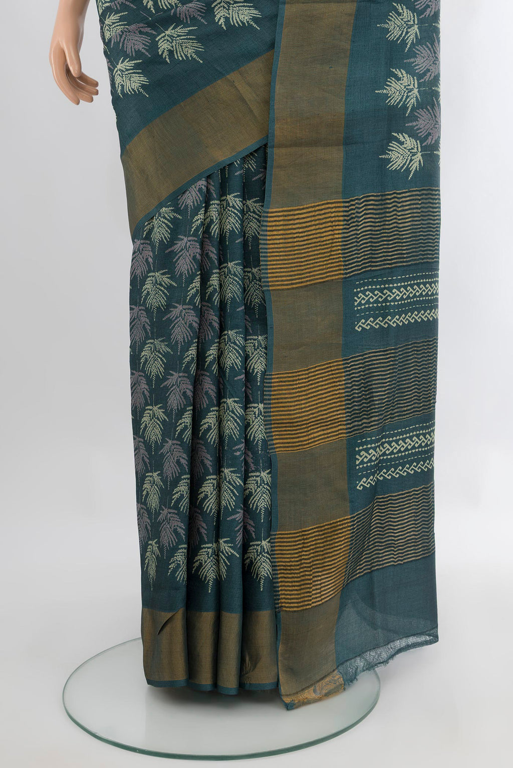 Pleats and pallu of Green Tussar Silk Saree with Floral Print on the body and Zari Border. 