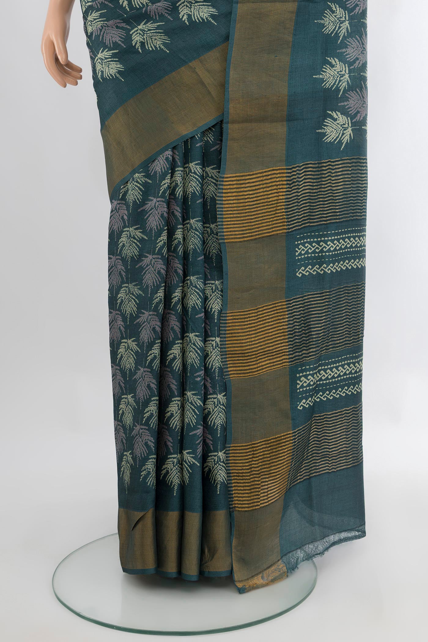 Pleats and pallu of Green Tussar Silk Saree with Floral Print on the body and Zari Border. 