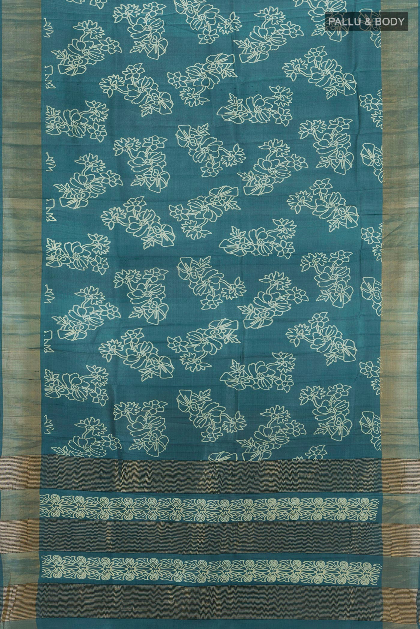 Flat view of Teal Tussar Silk Saree with Floral Print on the body and Zari Border. 