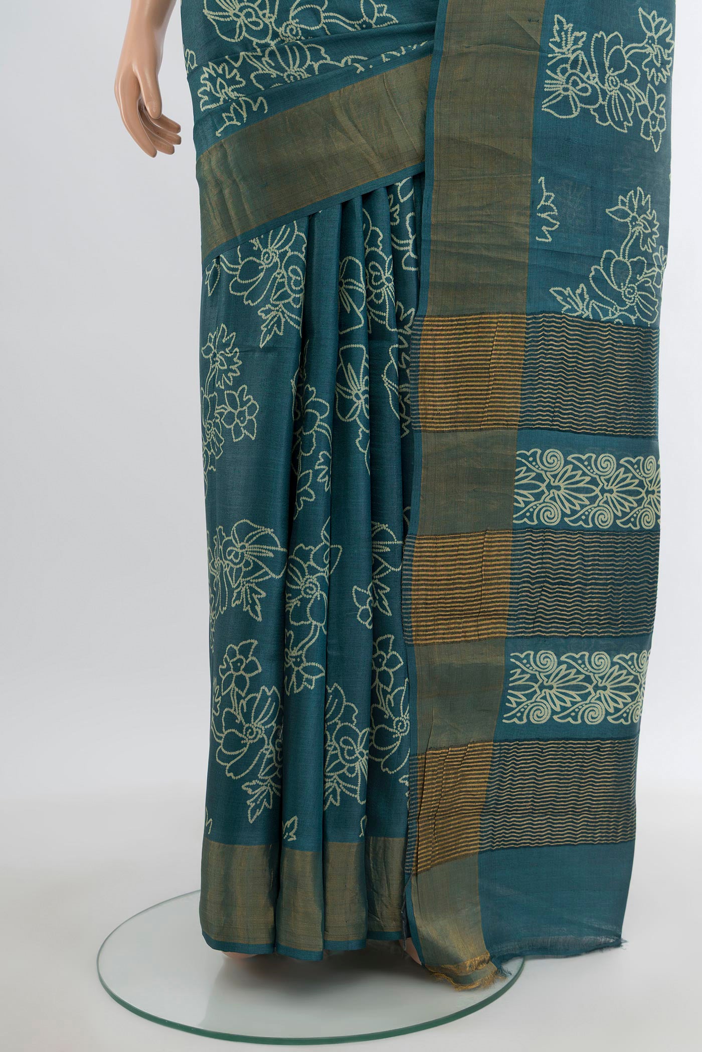 Pleats and pallu of Teal Tussar Silk Saree with Floral Print on the body and Zari Border. 
