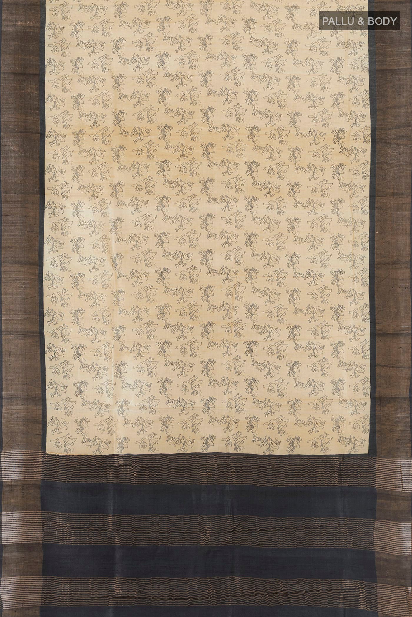 Flat view of Beige Tussar Silk Saree with Floral Print on the body and Zari Border. 