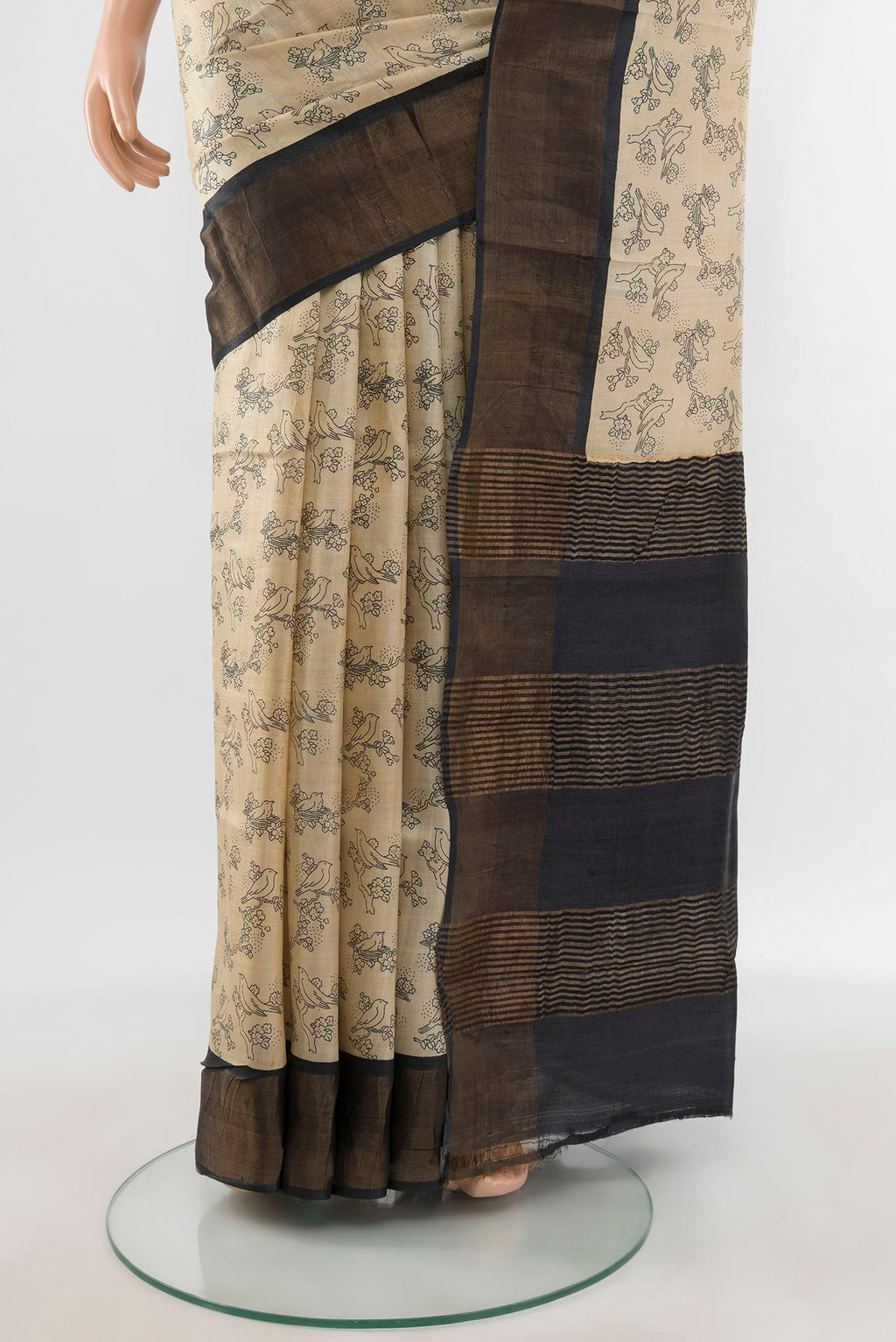 Pleats and pallu of Beige Tussar Silk Saree with Floral Print on the body and Zari Border. 