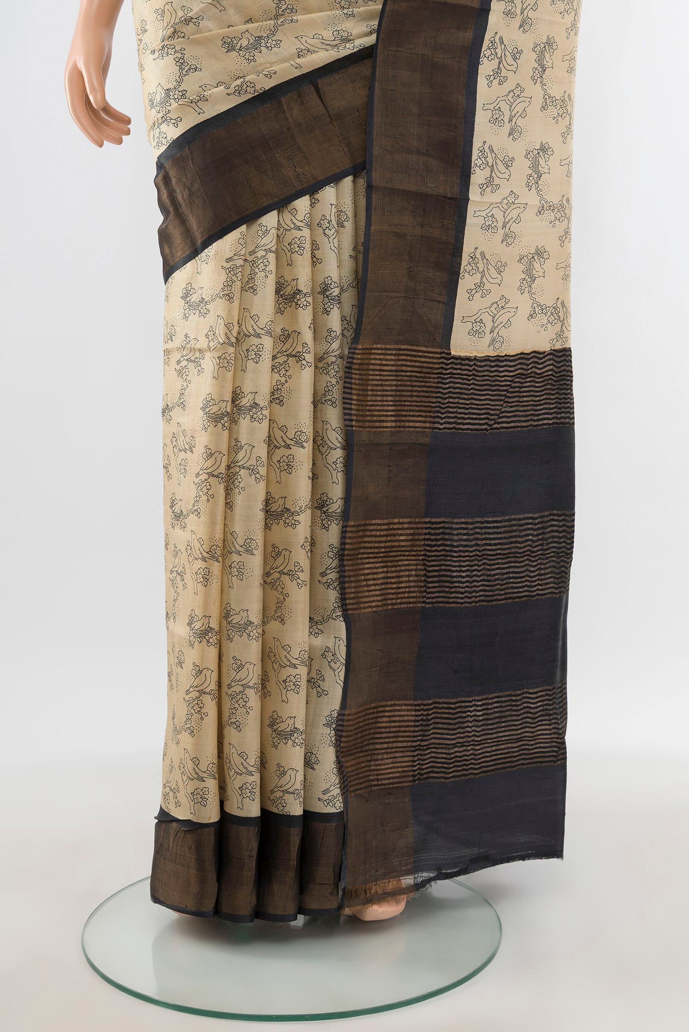 Pleats and pallu of Beige Tussar Silk Saree with Floral Print on the body and Zari Border. 