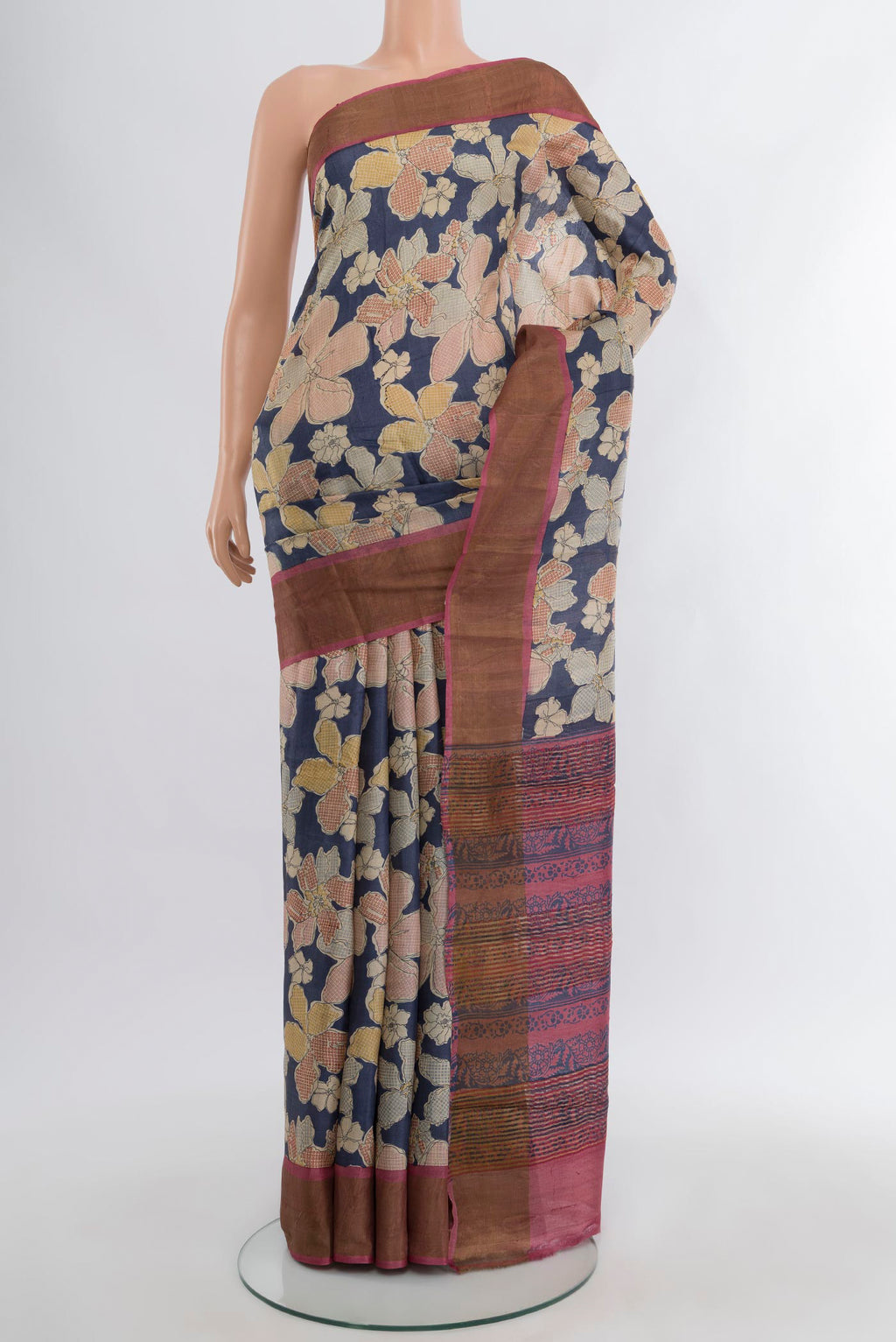 Navy Blue Tussar Silk Saree with Floral Print on the body and Zari Border.  displayed on a mannequin