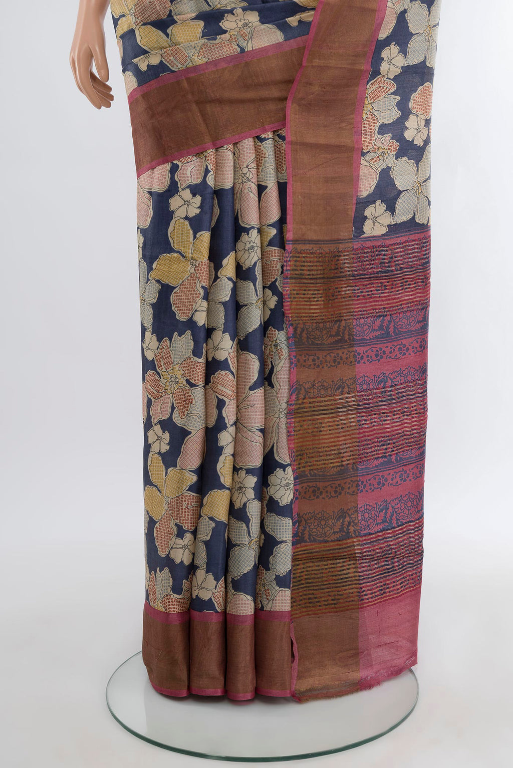 Pleats and pallu of Navy Blue Tussar Silk Saree with Floral Print on the body and Zari Border. 