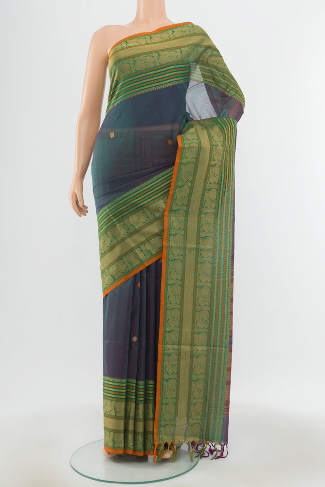 Peacock Blue Kora Cotton Saree with Zari Butta on the body and Silk Border.  displayed on a mannequin