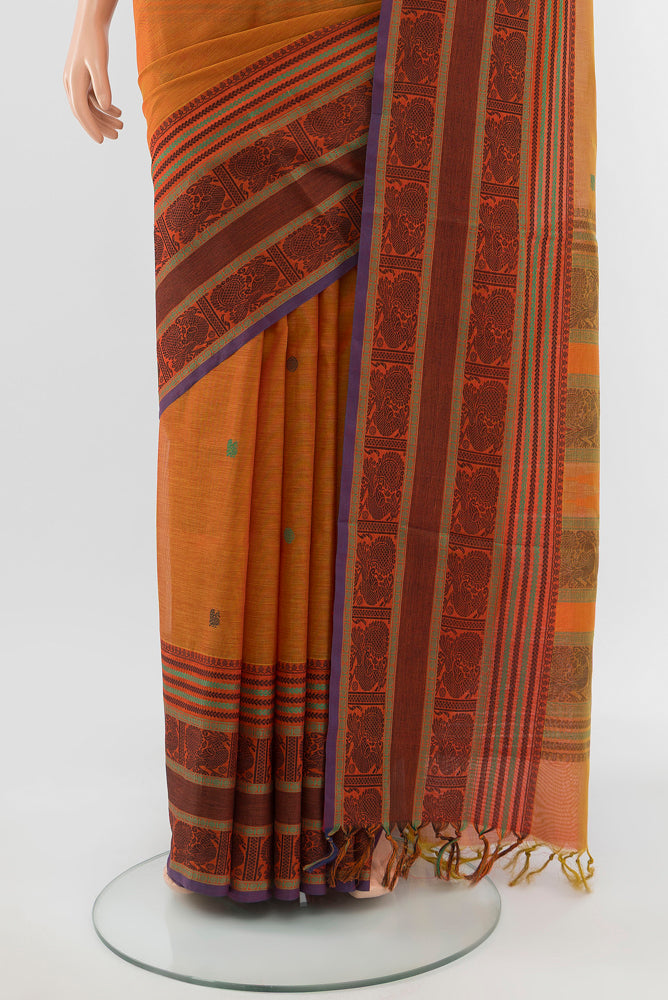 Pleats and pallu of Mustard Kora Cotton Saree with Zari Butta on the body and Silk Border. 