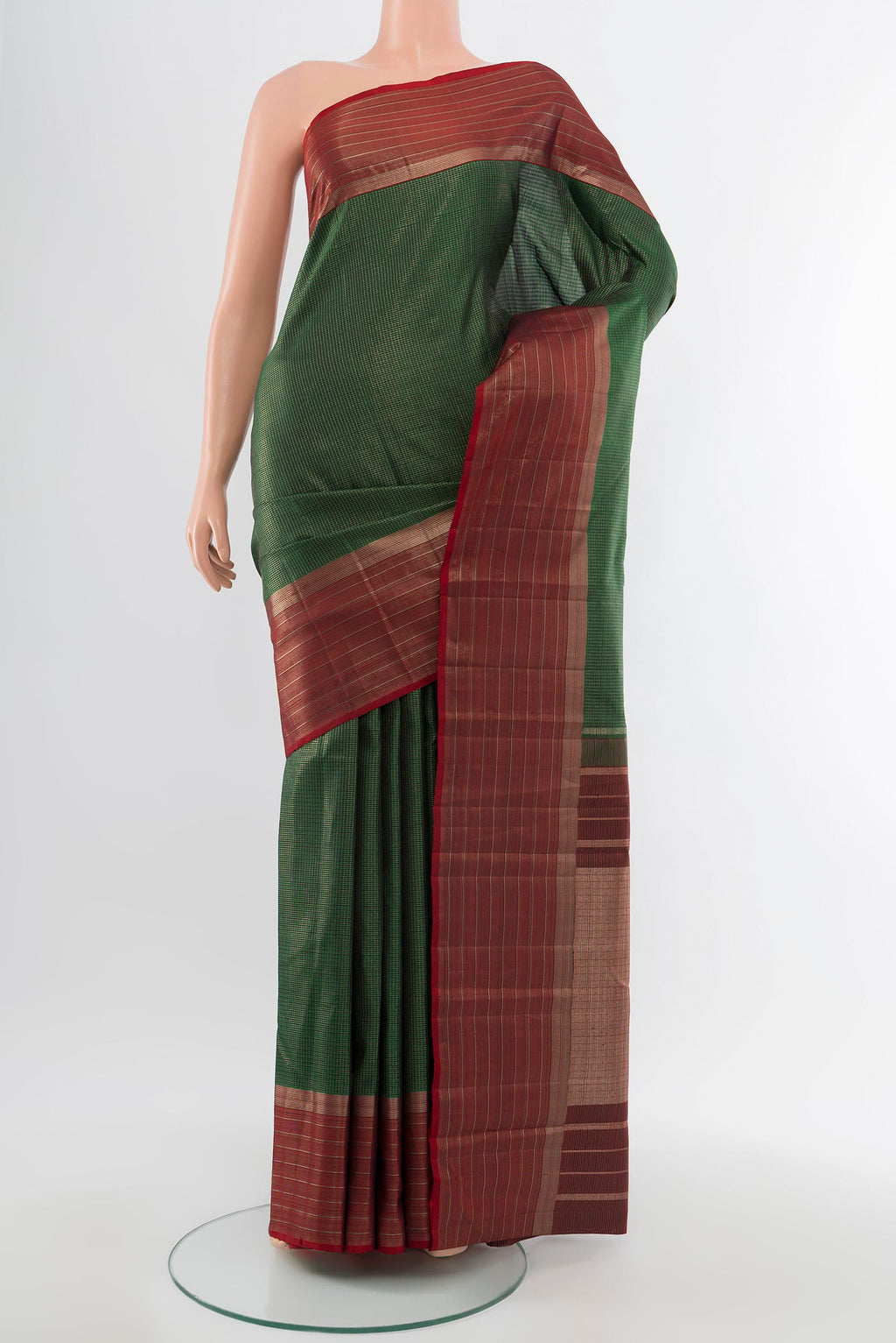 Pure Silk Pure Zari Bottle Green Kanjivaram Saree with Zari Butta on the body and Silk Border.  displayed on a mannequin