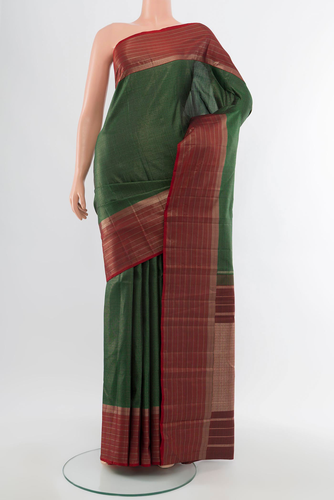 Pure Silk Pure Zari Bottle Green Kanjivaram Saree with Zari Butta on the body and Silk Border.  displayed on a mannequin