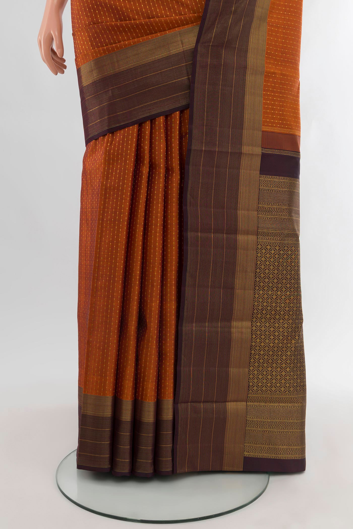 Pleats and pallu of Rust Kanjivaram Silk Saree with Zari Butta on the body and Plain Border. 